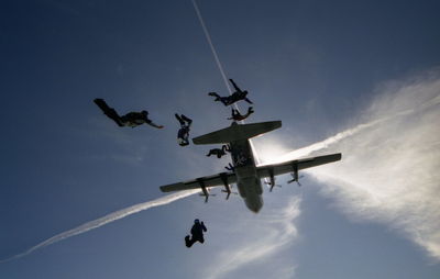 Low angle view of airplane flying against sky