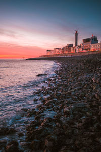 Scenic view of sea against orange sky