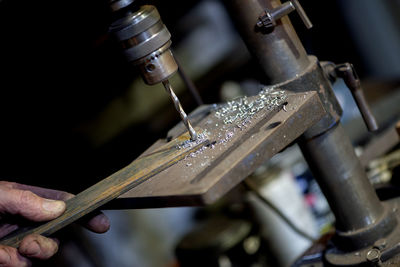 Blacksmith  drill press in garage. metalworker operating a bench drill inside  workshop. 