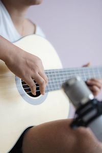 Close-up of man playing guitar