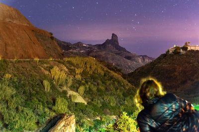 Scenic view of mountains against sky at night