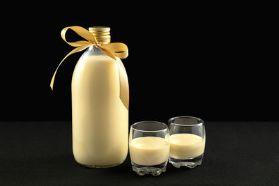 Close-up of drink on table against black background