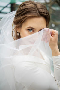 Portrait of smiling young woman wearing mask