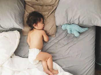 Directly above shot of baby lying on bed at home