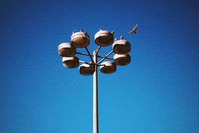 Low angle view of lamp post against blue sky