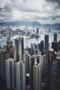 Aerial view of buildings in city against sky