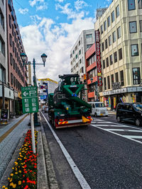 View of city street and buildings against sky