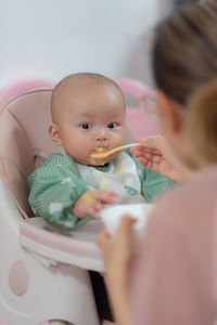 Portrait of cute baby girl with daughter at home