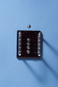 Close-up of guitar against blue background