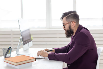 Side view of man using mobile phone