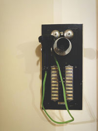 High angle view of telephone on table against wall