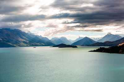 Scenic view of lake and mountains against sky