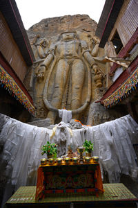 Low angle view of statue against building