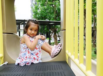 Portrait of cute girl smiling and posting on the playground