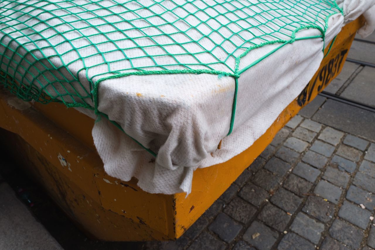 no people, textile, high angle view, day, indoors, close-up, pattern, still life, street, sidewalk, city, covering, furniture, absence, footpath, towel, chair, white color, paving stone, clean