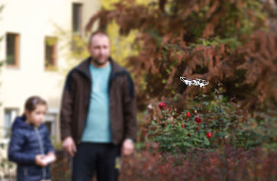 People standing by plants