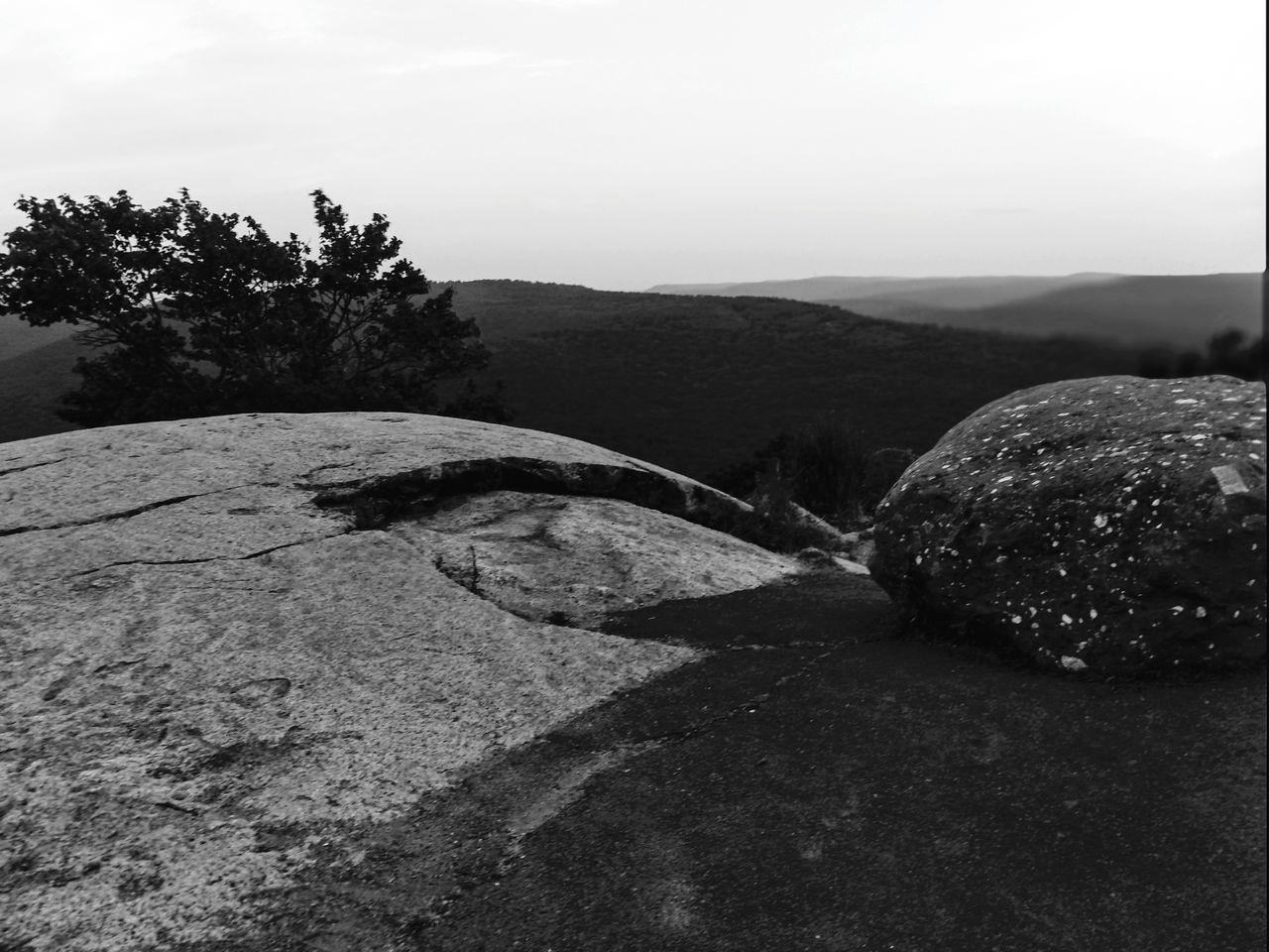 ROCKS ON LAND AGAINST SKY