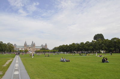 Group of people in park against sky