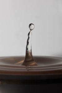 Close-up of liquid splashing against white background