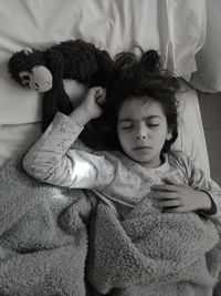 High angle view of girl lying down on bed