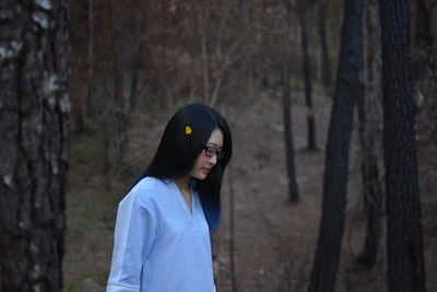 Low section of person standing on tree trunk