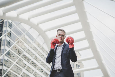 Businessman wearing boxing gloves