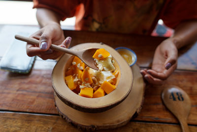 Cropped hand of woman preparing food