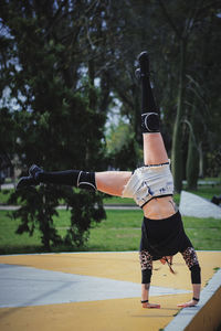 Woman exercising on field