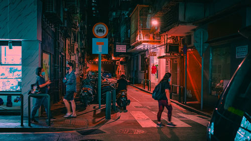 People walking on street at night