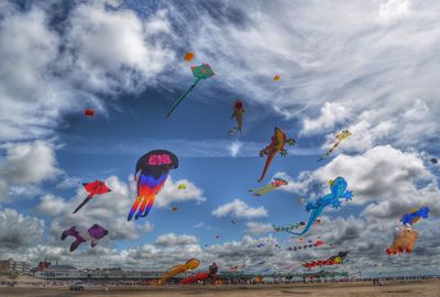 Low angle view of kites flying in sky