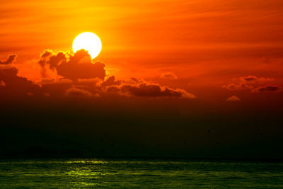 Scenic view of sea against romantic sky at sunset