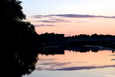 Scenic view of river against sky at dusk
