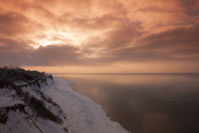 Snow-covered coast of baltic sea on peninsula fischland in germany with mystical light atmosphere