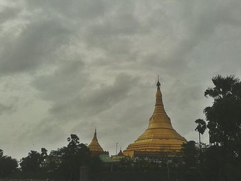 Low angle view of temple against cloudy sky