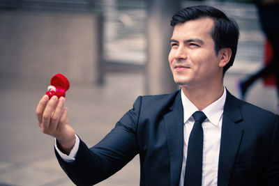 Portrait of young man holding camera