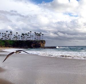 Scenic view of sea against cloudy sky