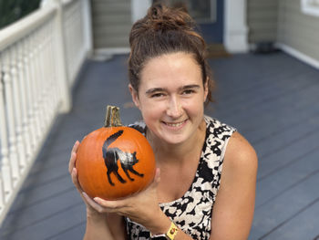 Portrait of young woman holding bauble