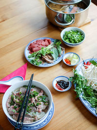 High angle view of soup with vegetables on table