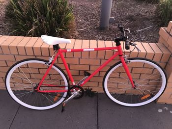 High angle view of bicycle parked on footpath