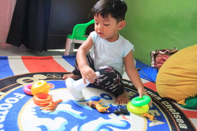 Boy playing with toy at home