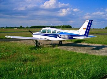 View of airplane on airport runway against sky