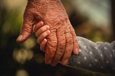 Cropped image of people with holding hands