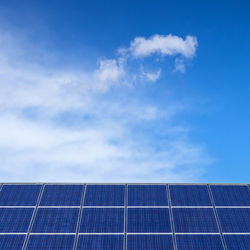 Scenic view of solar panels against blue sky