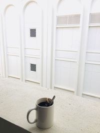 Coffee cup on white door