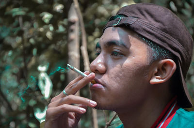 Close-up portrait of woman smoking cigarette