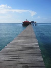 Pier over sea against sky