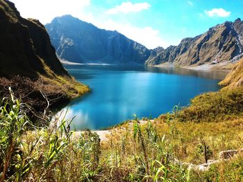 Scenic view of lake and mountains against sky