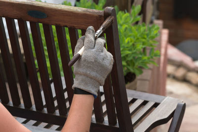 Close-up of hand on chair