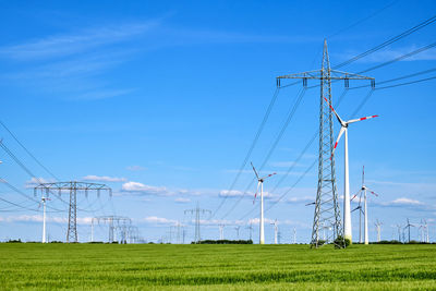 Electricity pylon on field against sky