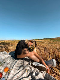 Woman on field against clear sky